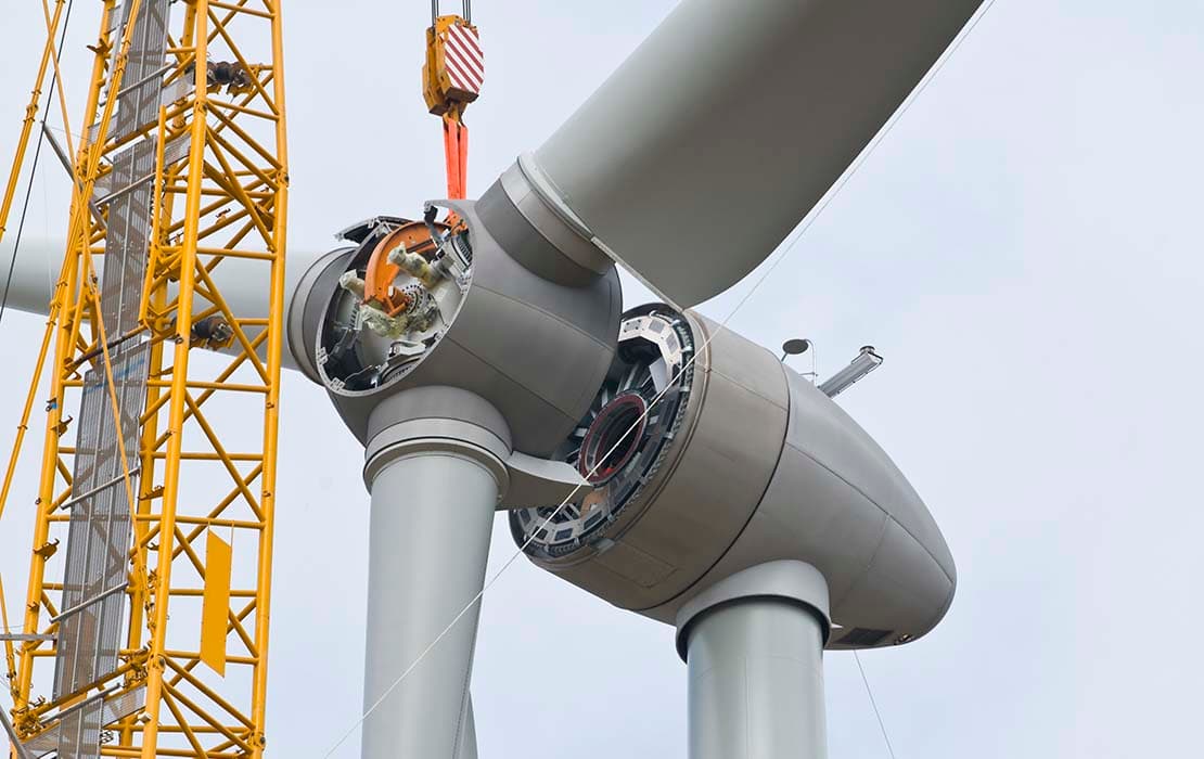 Photo of rotor blades being installed on a wind turbine