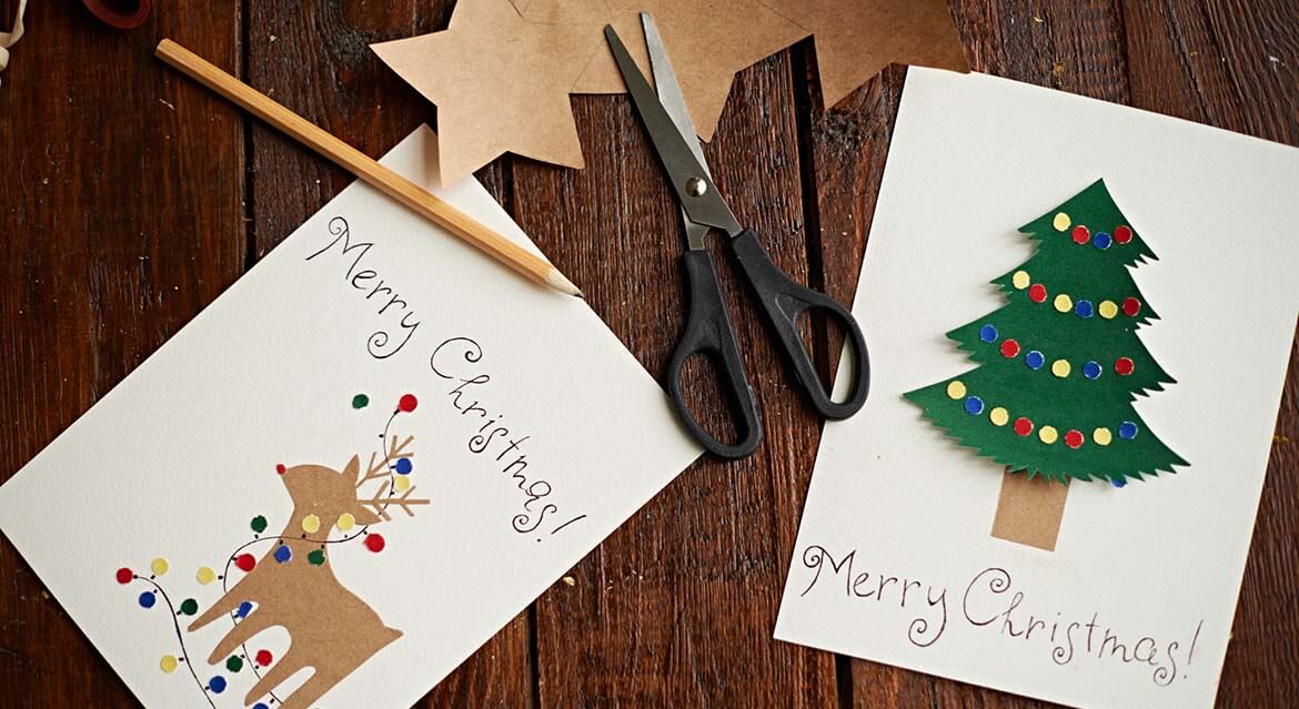 Homemade Christmas cards featuring a deer and Christmas tree