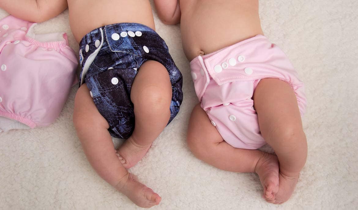 Photo of two babies in reusable nappies