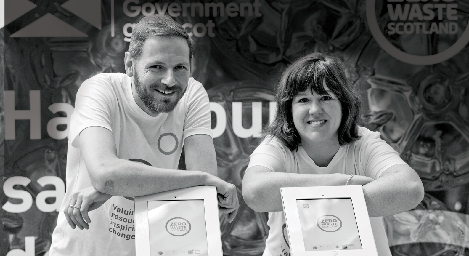 Two Zero Waste Scotland colleagues standing in front of tablet devices