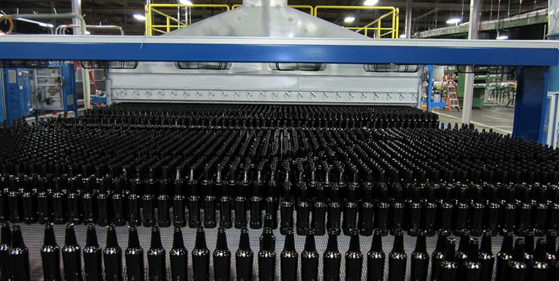 Photo of rows of bottles in a factory