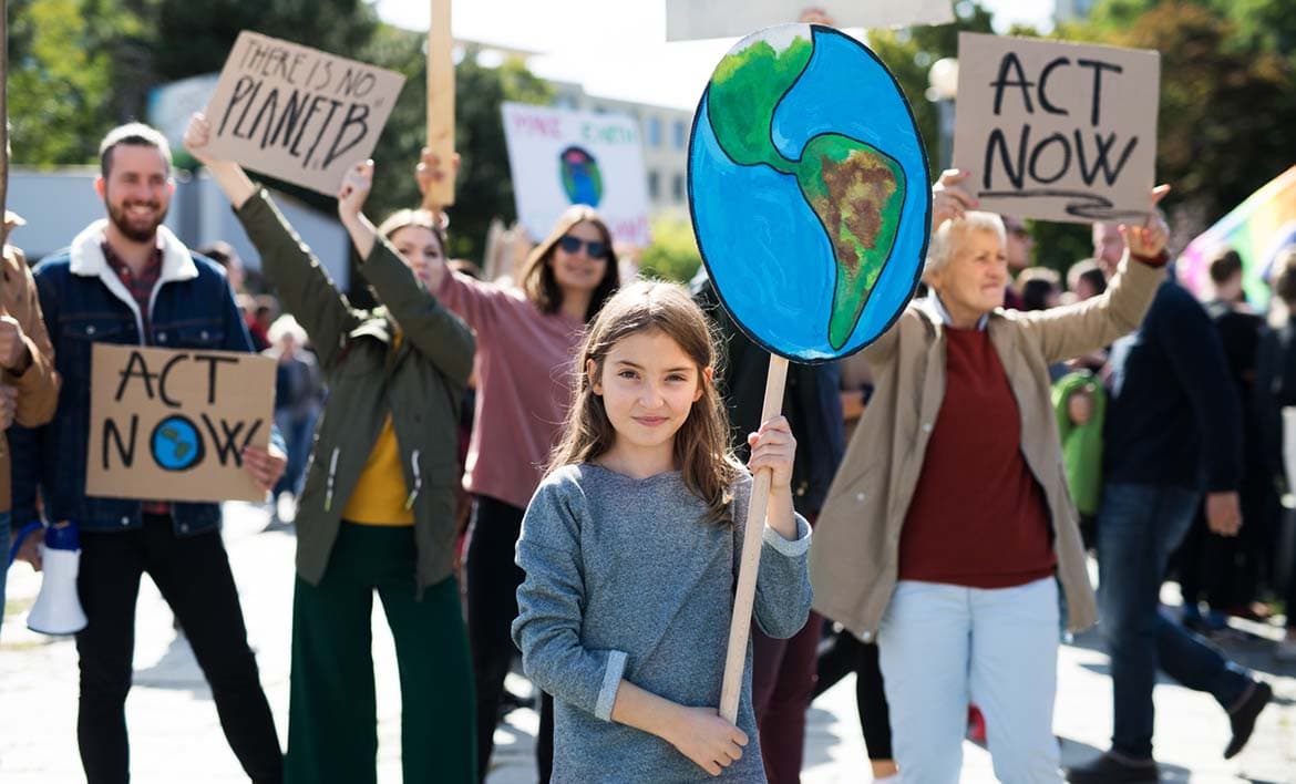 Photo of a group of people holding climate change placards