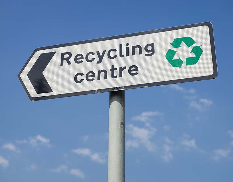 Signpost with directions to a local recycling centre