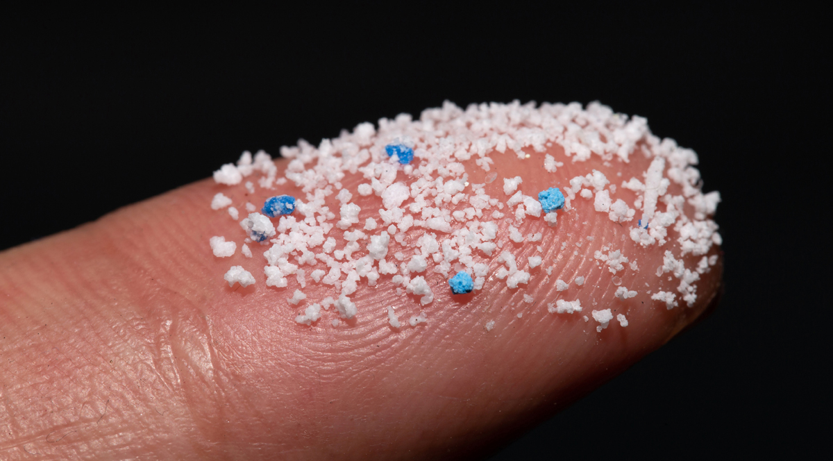 A finger tip covered a lots of microplastics