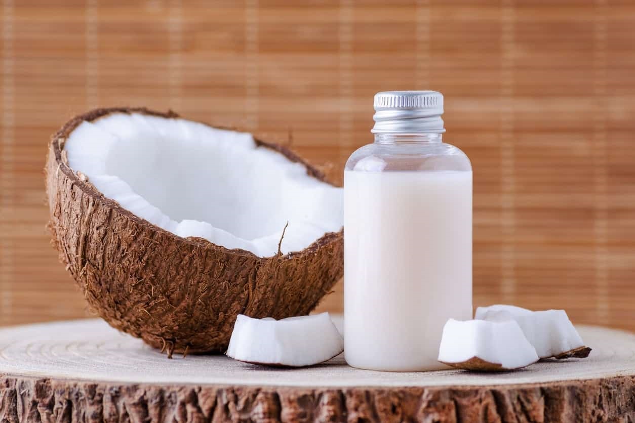 coconut shell and small reusable shampoo bottle