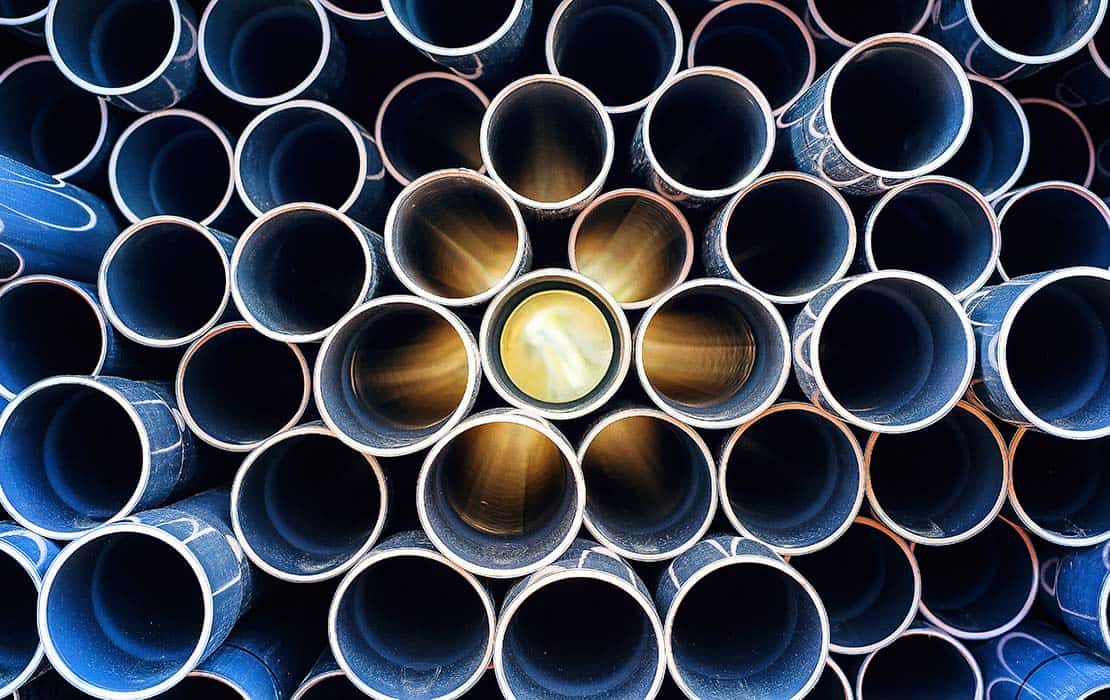 Photo of plastic construction pipes stacked u